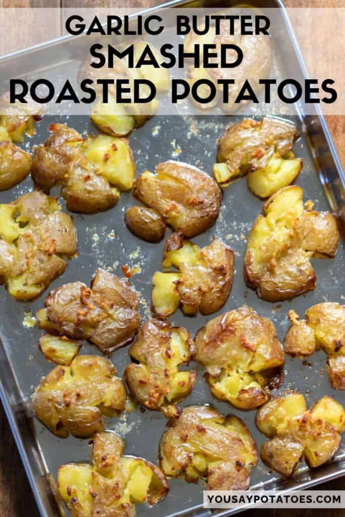 A baking sheet of potatoes, with text: Garlic Butter Smashed Roasted Potatoes.
