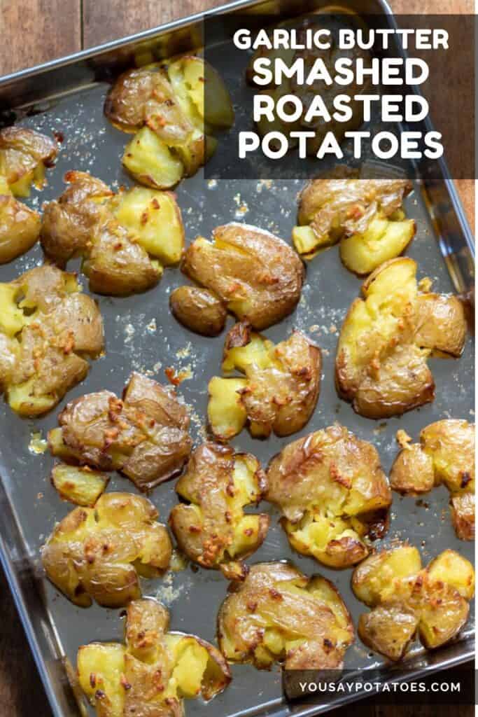 A baking sheet of potatoes, with text: Garlic Butter Smashed Roasted Potatoes.