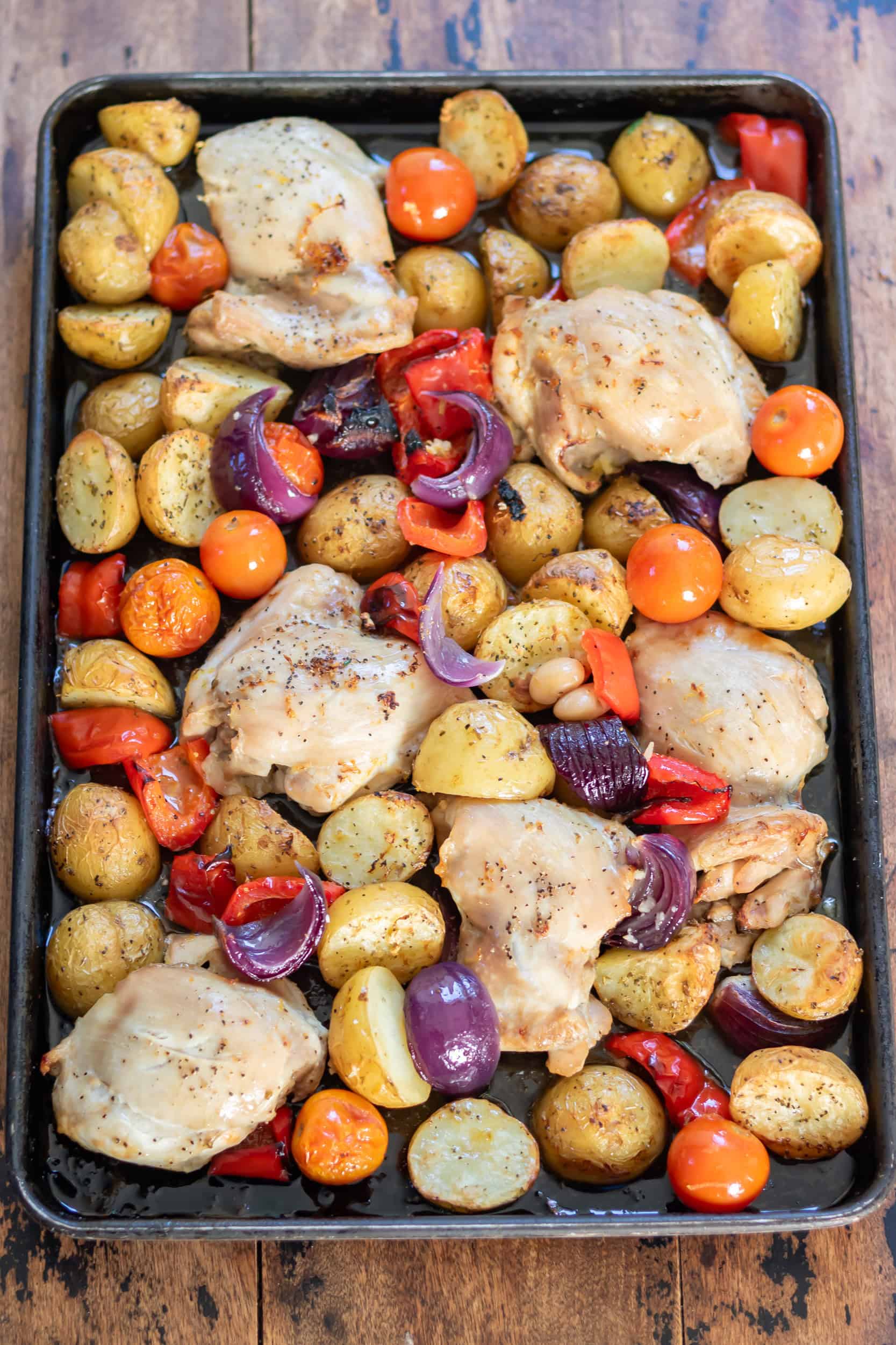 A sheet pan of Greek chicken and potatoes.