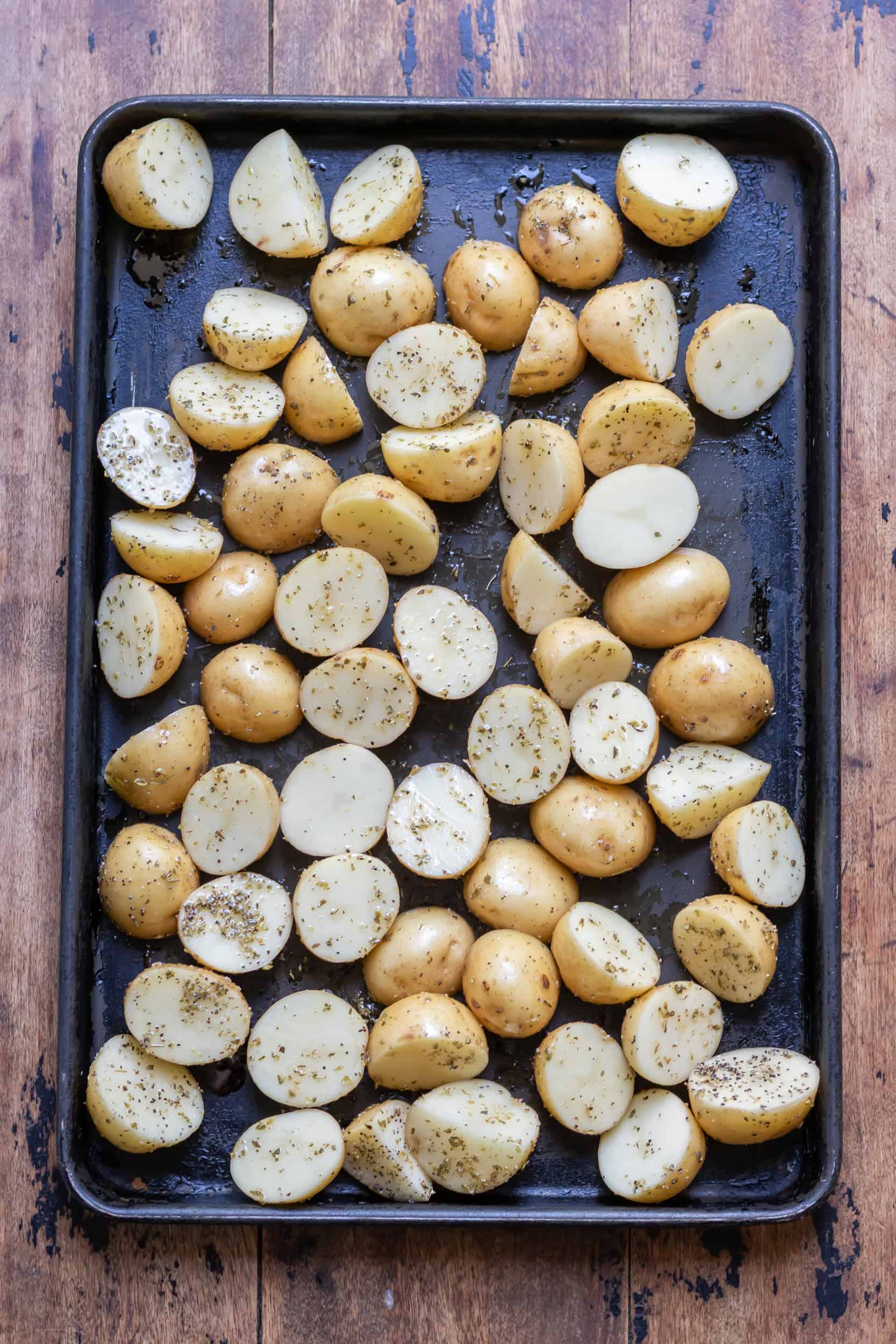 Seasoned potatoes on a baking sheet.
