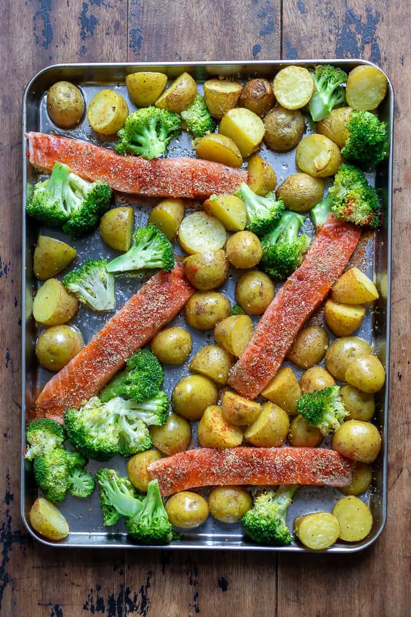 Seasoned salmon fillets and broccoli added to the partially cooked potatoes.