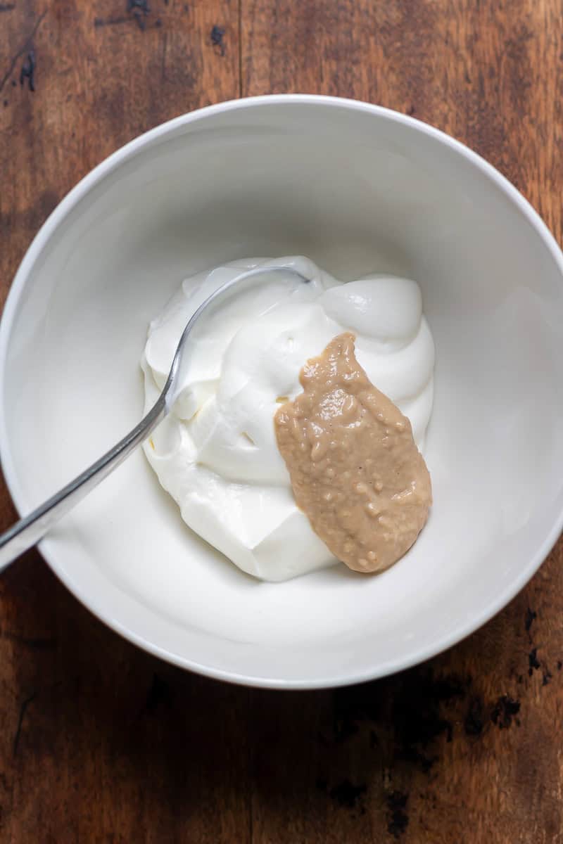 Stirring horseradish into Greek yogurt.