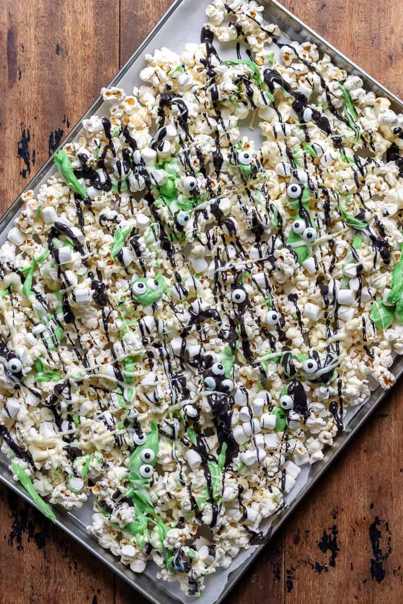 Tray of Halloween Monster Popcorn drizzled with coloured white chocolate and sprinkled with candy eyes and mini marshmallows.